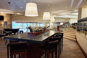 Relax in our stylish lobby, featuring a spacious bar area with a long counter and comfortable seating.