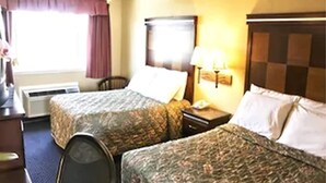 A hotel room with two beds, a desk, a chair, an air conditioning unit, and a window with curtains. - Inn@Bayshore (San Mateo)