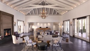 A spacious living room with a high ceiling, a fireplace, and a large window. - Hyatt Regency Sonoma Wine Country (Santa Rosa)