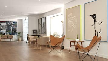 A modern living room with a wooden floor, a sofa, a coffee table, and a unique orange chair.