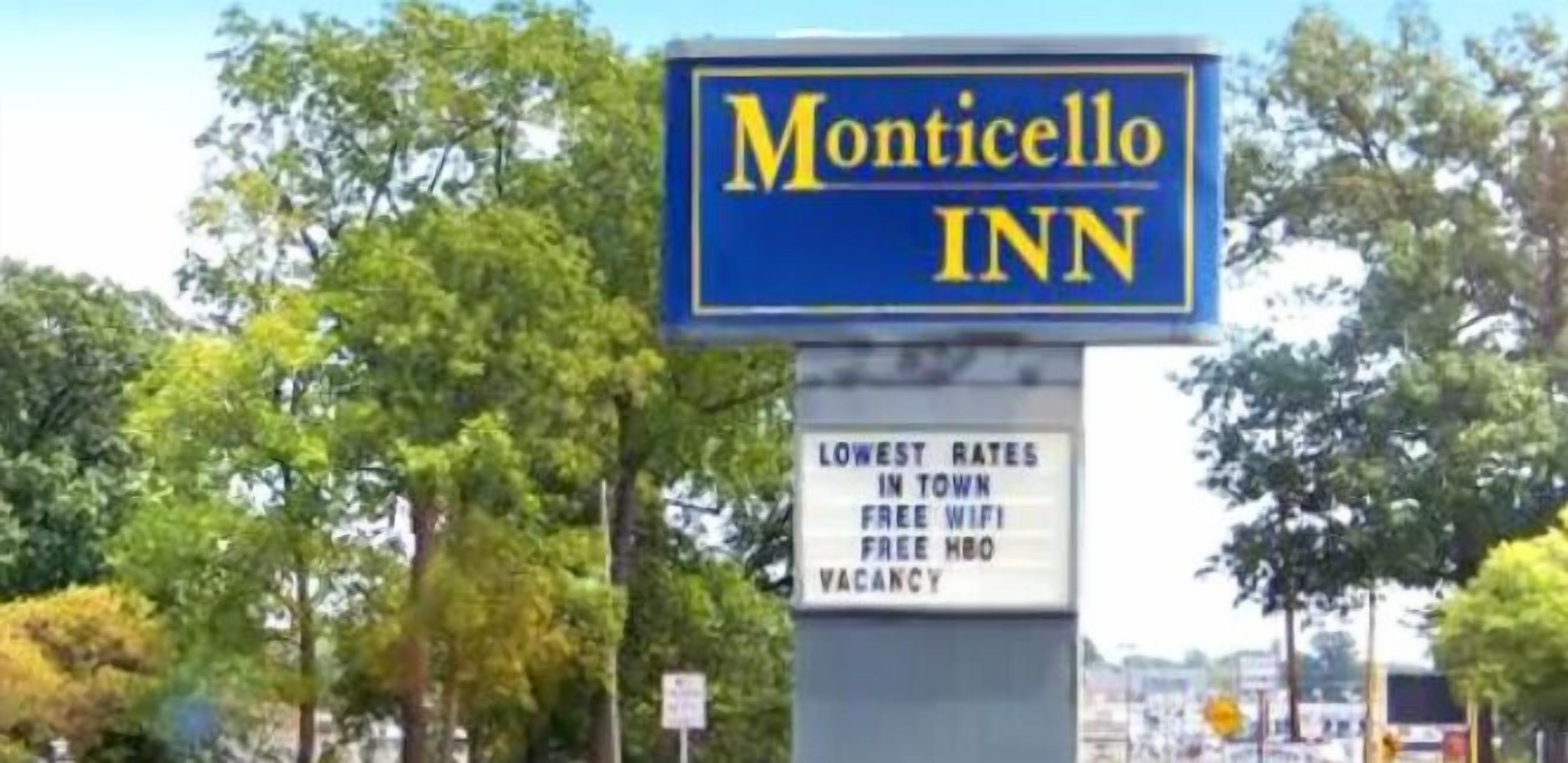 A sign for Monticello Inn advertising the lowest rates in town, free WiFi, free HBO, and a vacancy.