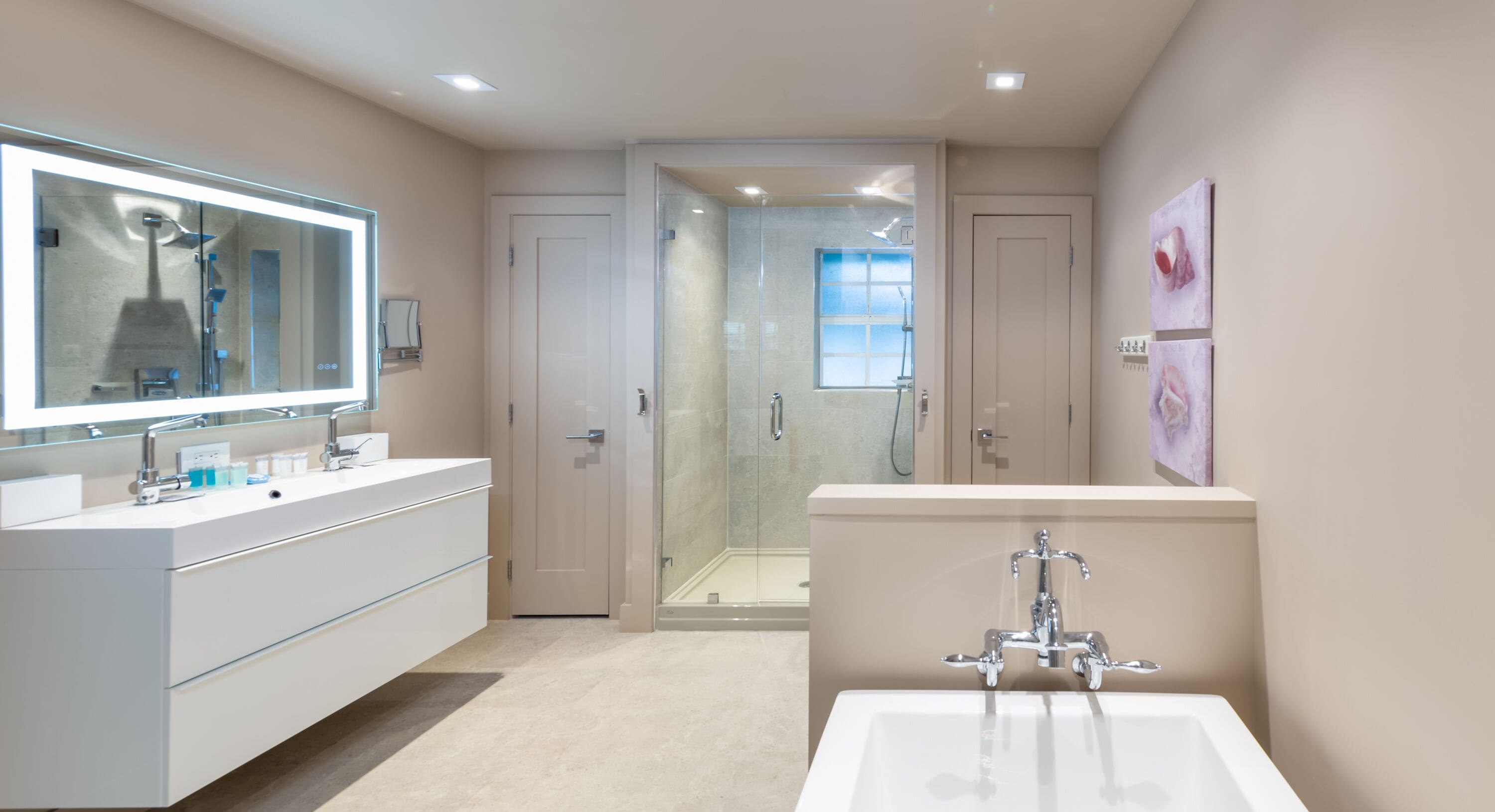 A modern bathroom with a large mirror, a walk-in shower, and a bathtub.