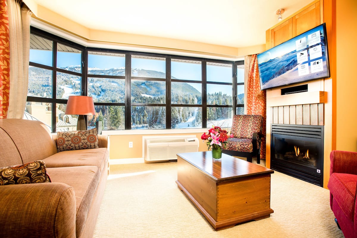 Premium Suite, 2 Bedrooms, Mountain View | Living room | 50-inch TV with cable channels, fireplace, DVD player