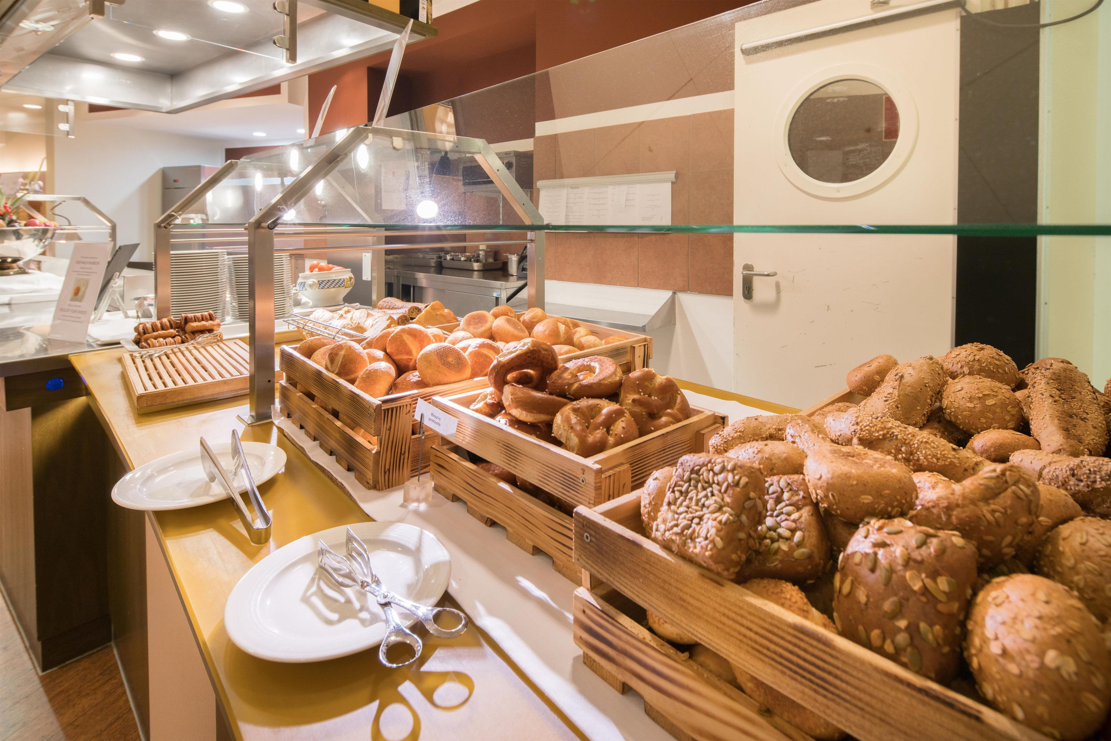 A buffet area with various baked goods displayed in wooden crates.