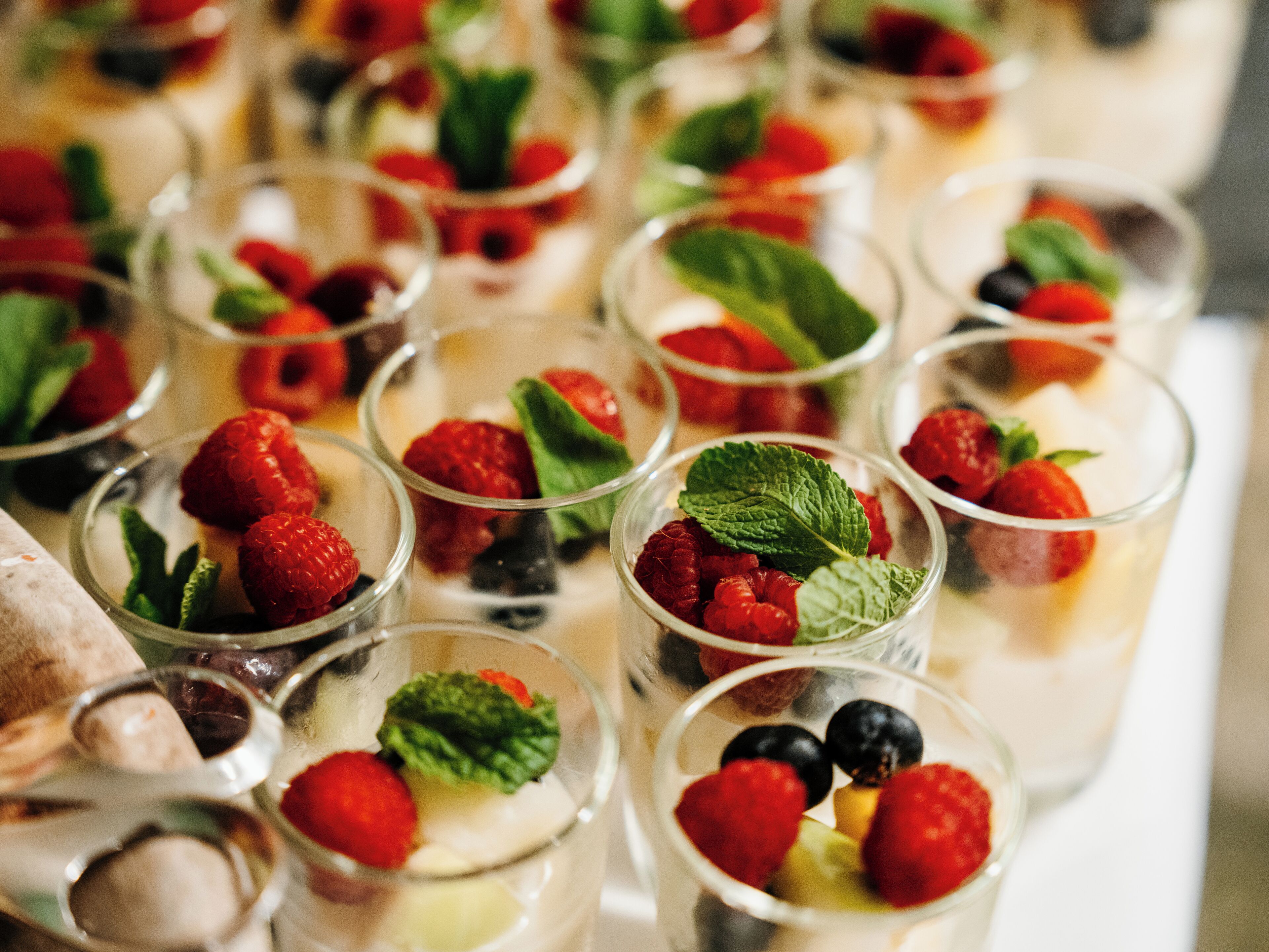 A variety of dessert cups arranged on a table.