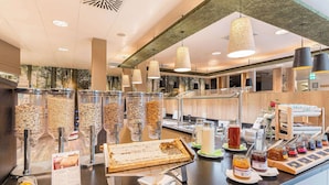 A buffet area with various food items and condiments. - Best Western Hotel Muenchen Airport (Erding)