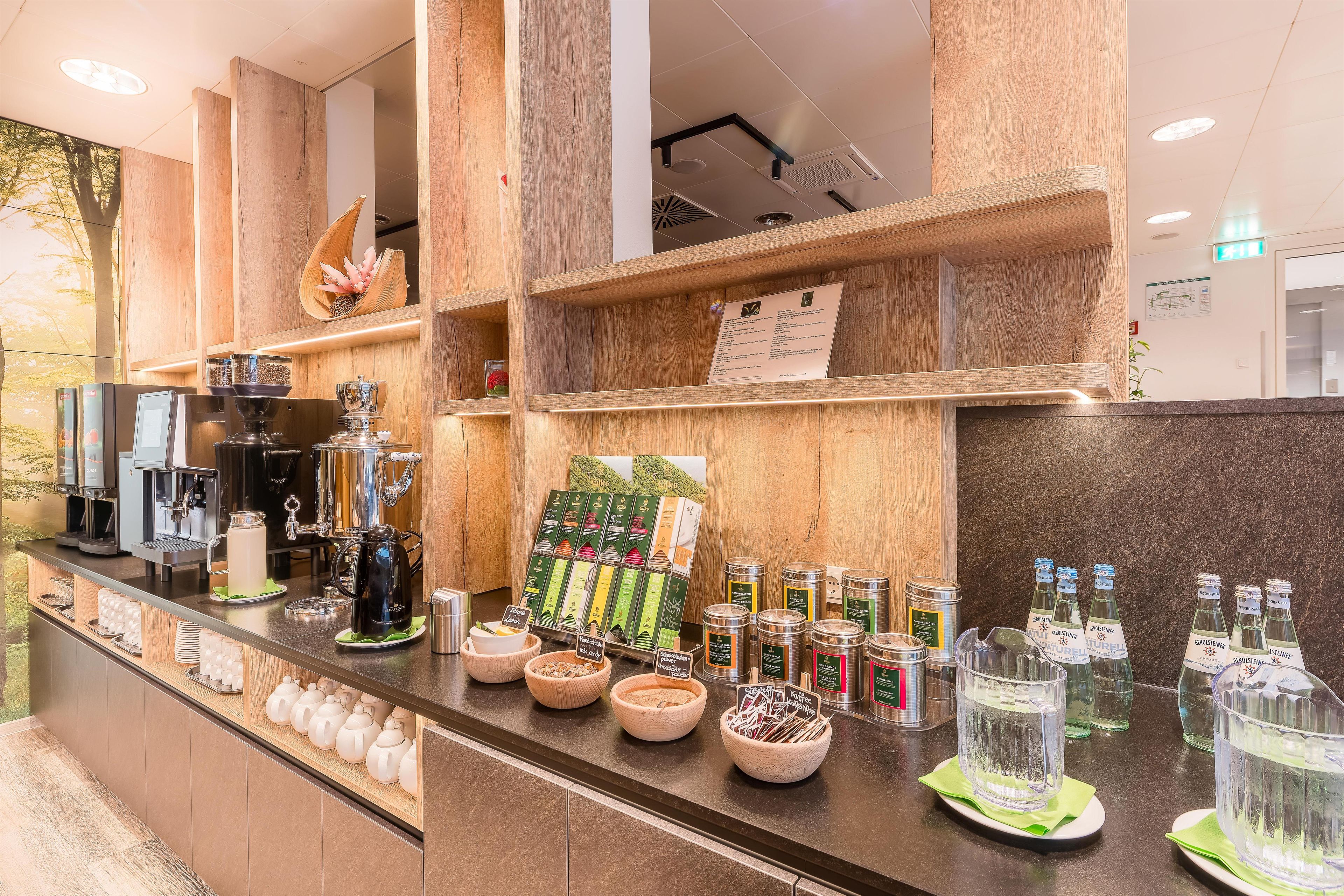 A coffee bar with espresso machines, a variety of coffee beans, and a selection of teas.