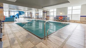 A large indoor swimming pool with a blue slide, seating area, and clear poolside views. - Fairfield Inn & Suites by Marriott St. John's Newfoundland (St. John's)