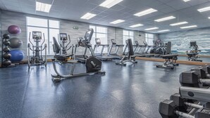 A gym with various exercise equipment, large windows, and a mirrored wall. - Fairfield Inn & Suites by Marriott St. John's Newfoundland (St. John's)