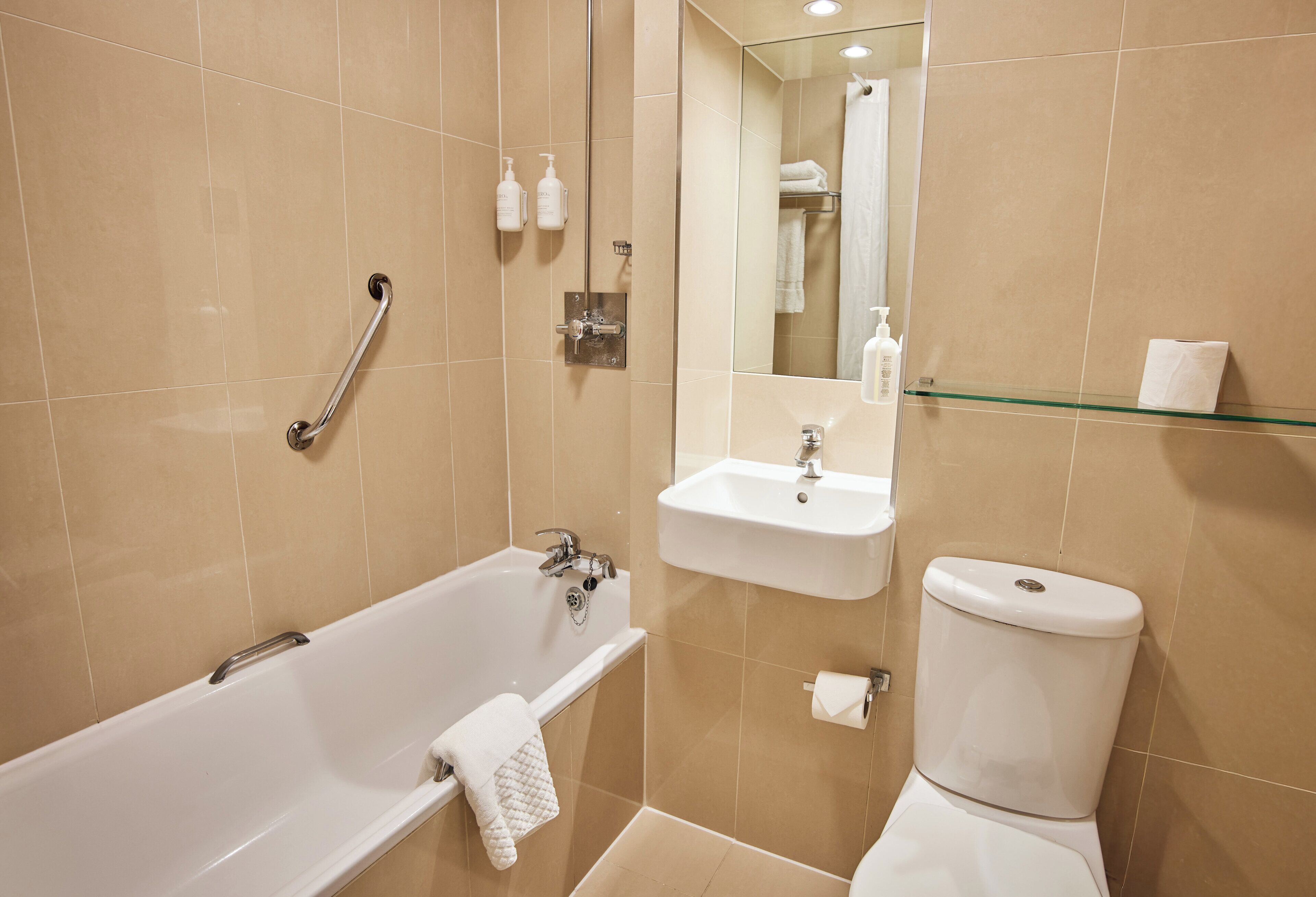 A bathroom with a bathtub, a sink, and a toilet.