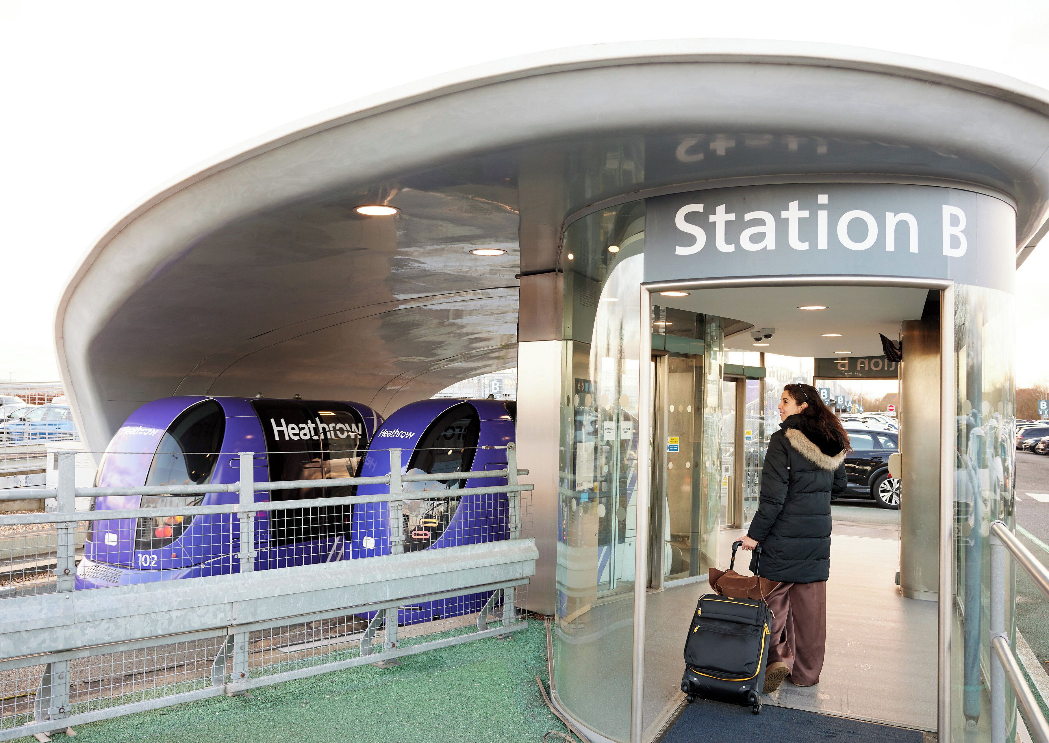 A modern station entrance with a clear sign reading "Station B".