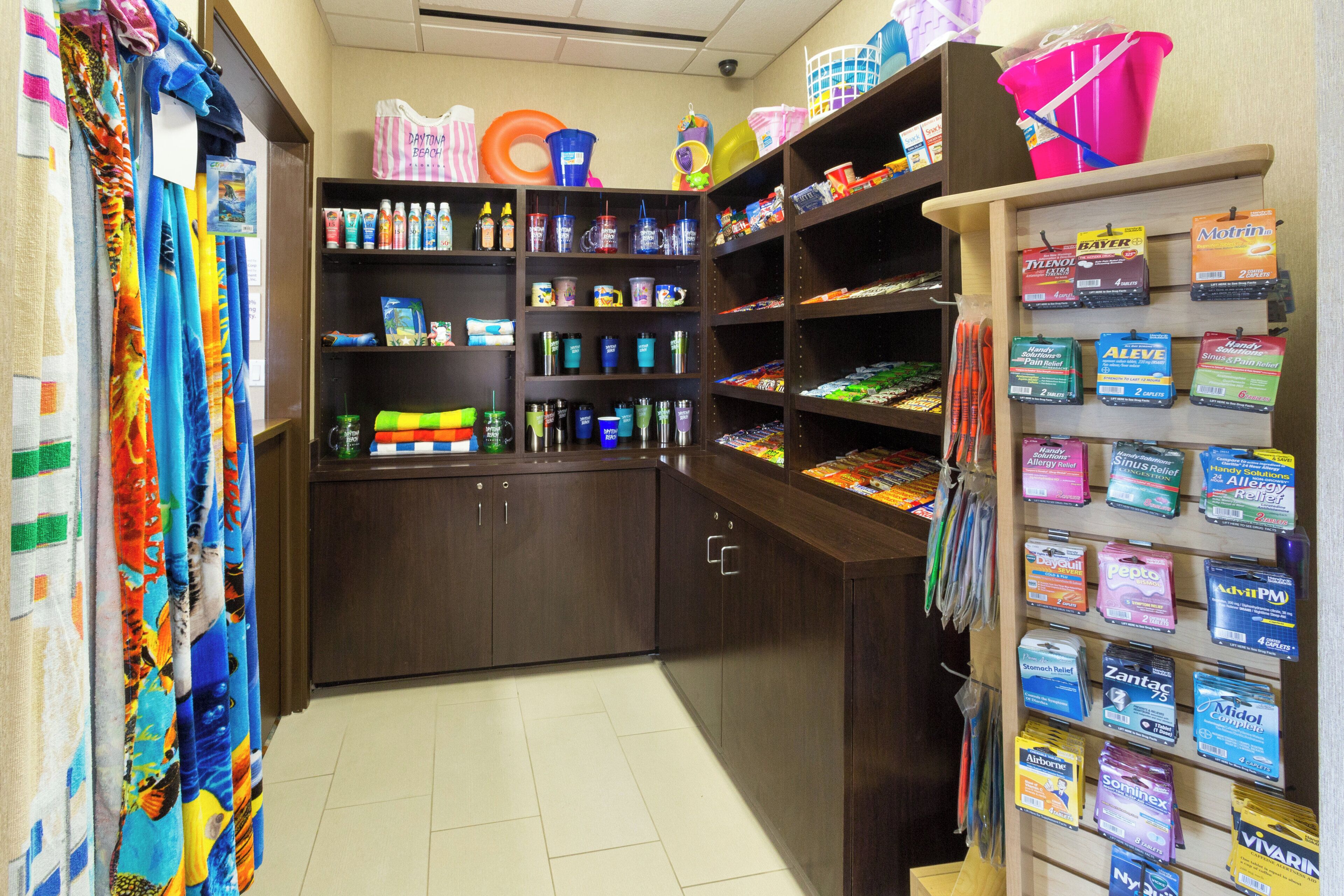 A pharmacy with shelves stocked with various medications and health products.