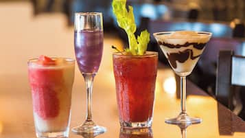 Three different cocktails on a bar counter.