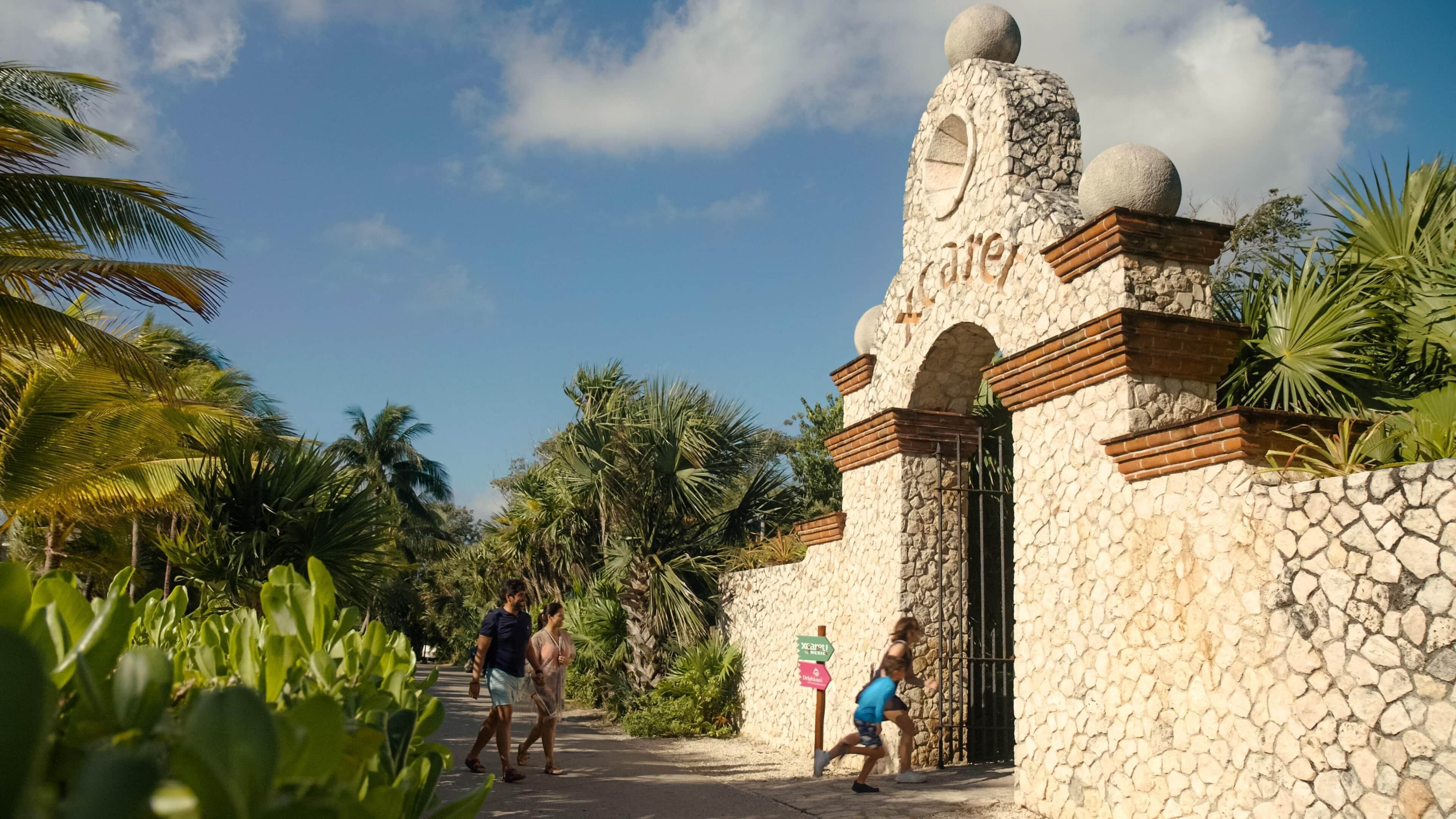 A stone entrance with a sign for 'Xcaret'.