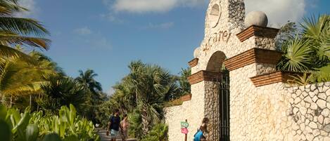 A stone entrance with a sign for 'Xcaret'.