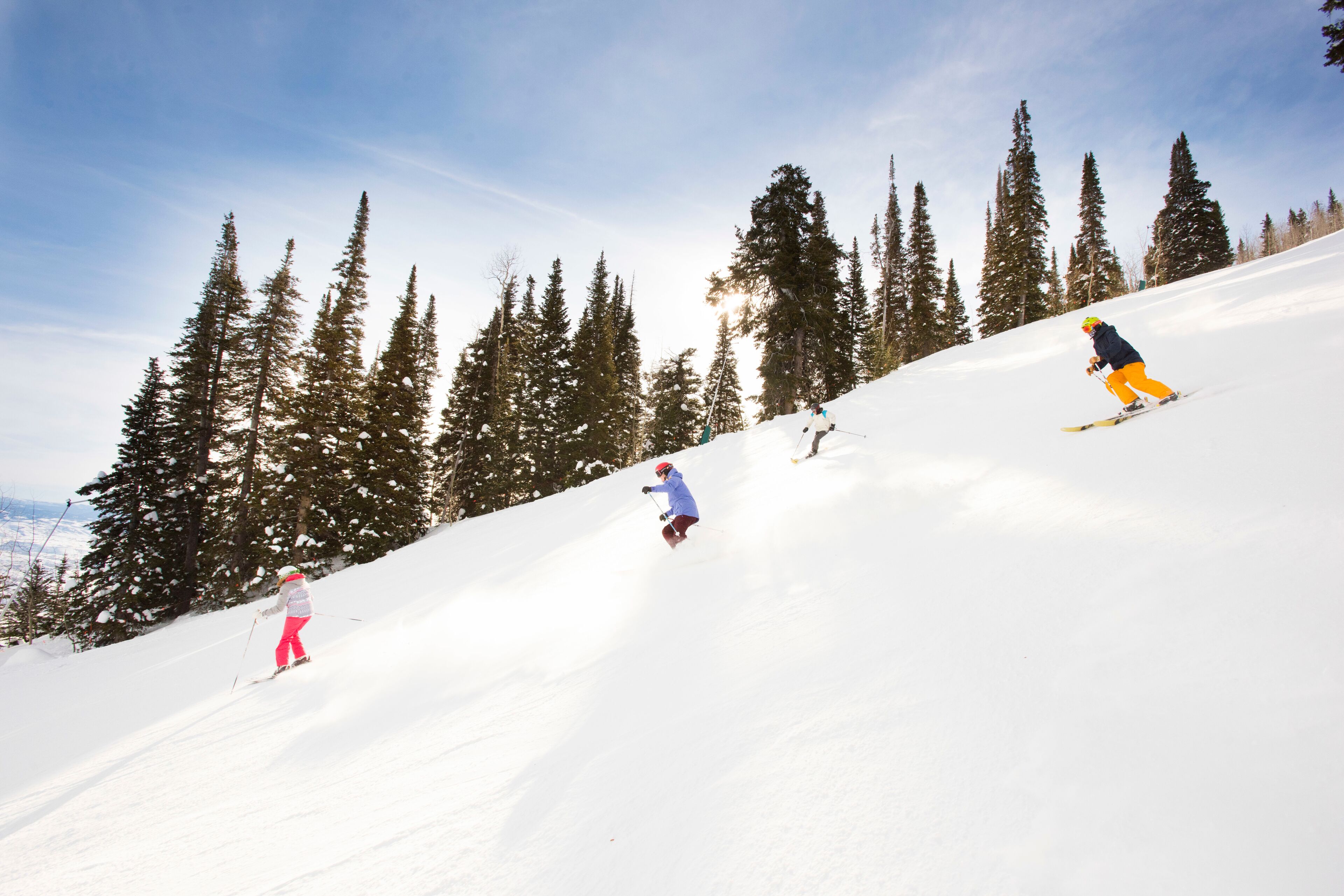 A snowy ski slope with skiers.