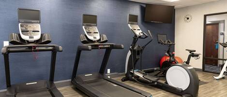 A fitness center with treadmills, an elliptical, and a stationary bike.