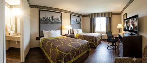 A hotel room with two beds, a desk, a television, and a cityscape painting on the wall.
