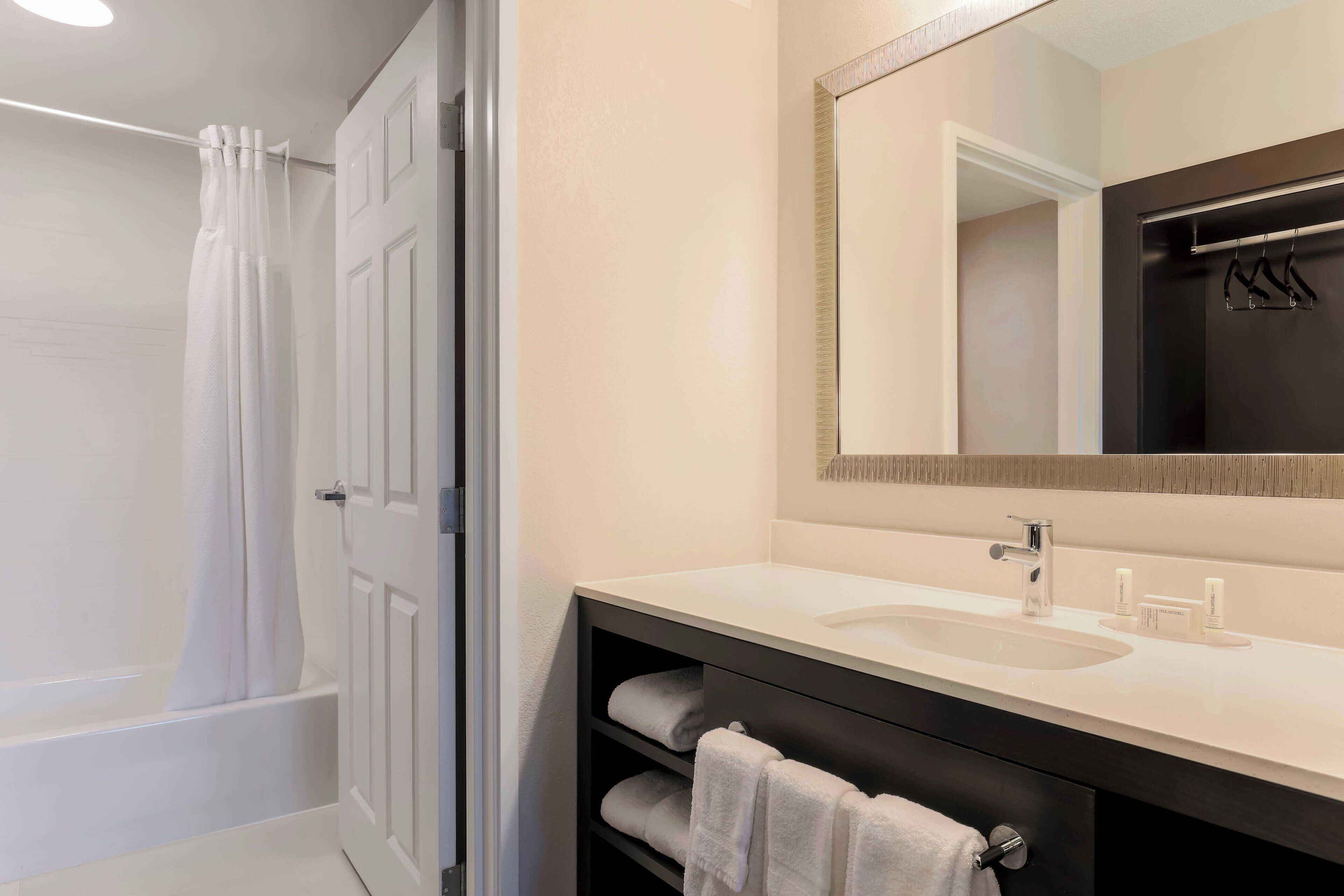 combined shower/bathtub, designer toiletries, hair dryer, towels