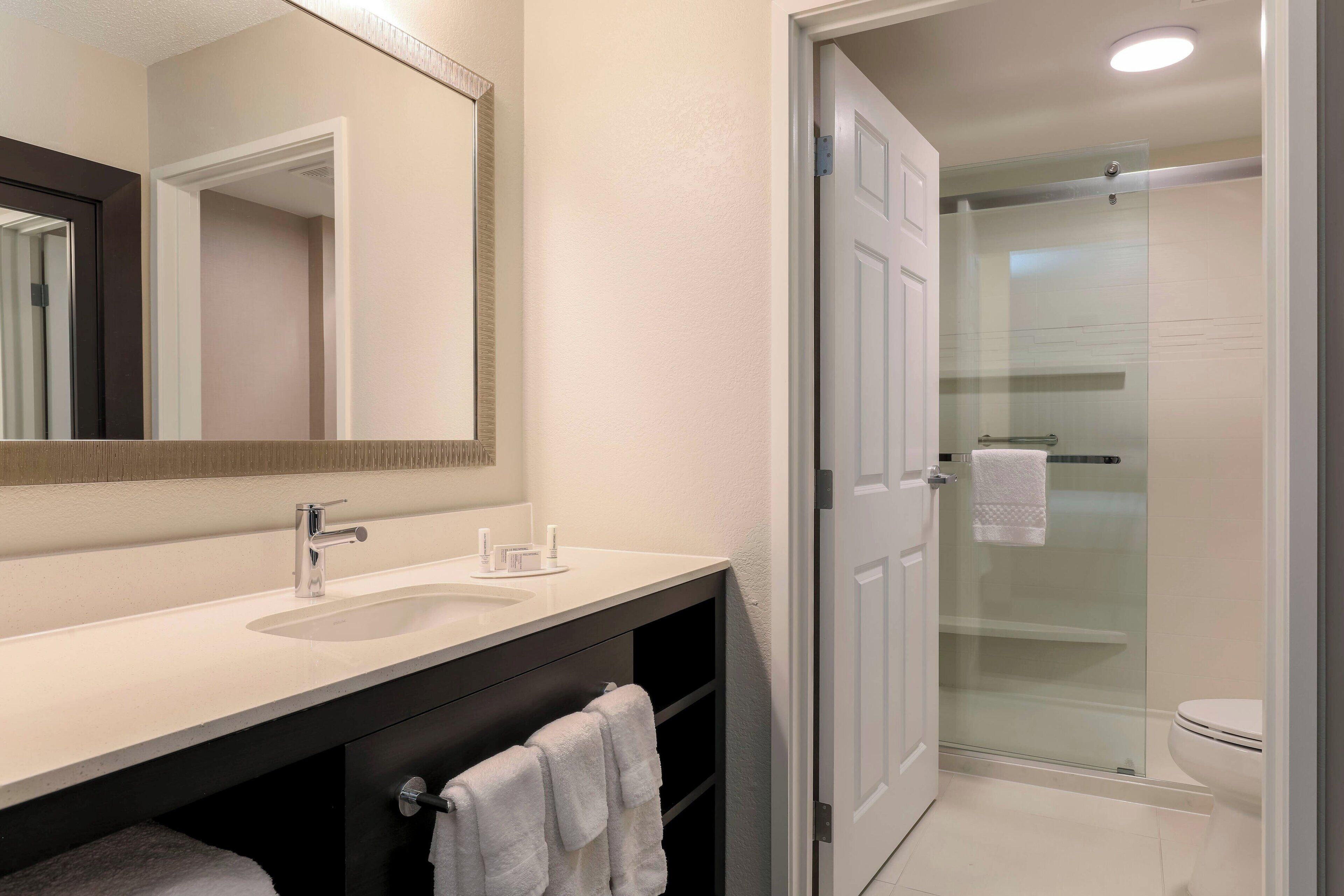 combined shower/bathtub, designer toiletries, hair dryer, towels