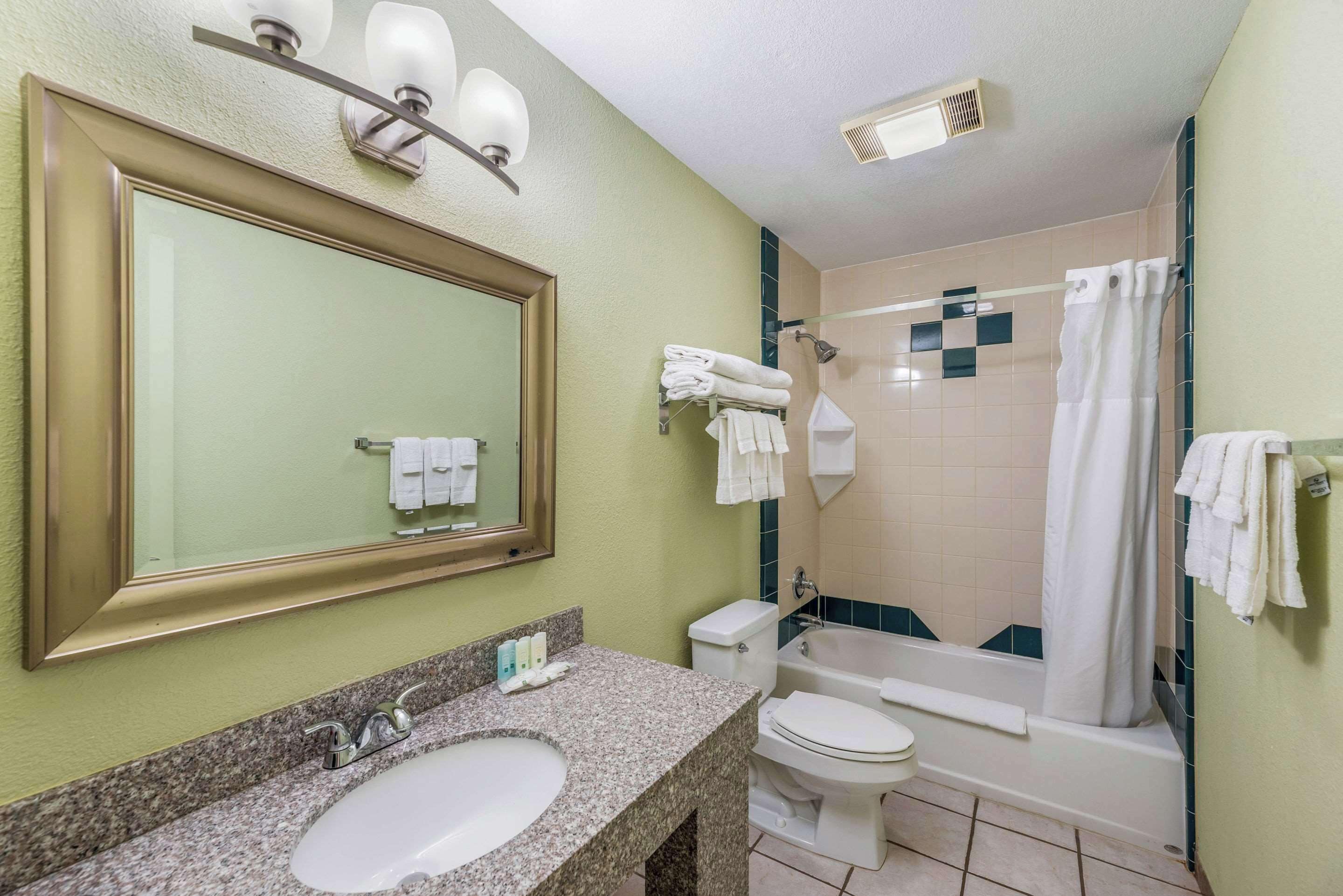 A bathroom with a sink, toilet, and bathtub.