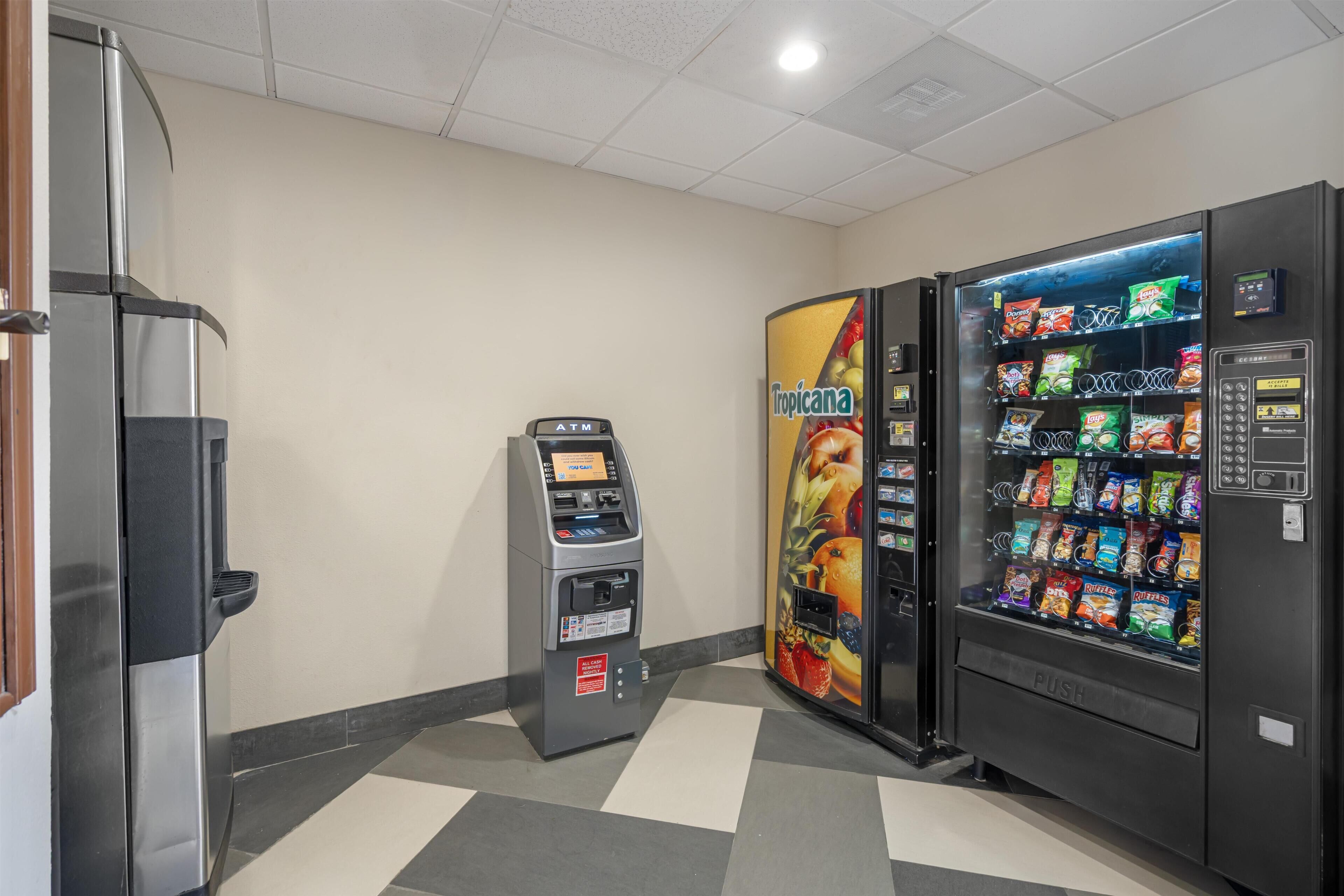 A vending machine with a tropical fruit theme, an ATM, and a push button for payment.