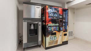 A vending machine with a water dispenser and a beverage vending machine labeled 'Smart Snacks Naturals 2GO'. - Red Roof Inn PLUS+ Columbus - Worthington (Columbus)