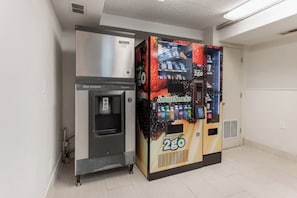 A vending machine with a water dispenser and a beverage vending machine labeled 'Smart Snacks Naturals 2GO'. - Red Roof Inn PLUS+ Columbus - Worthington (Columbus)
