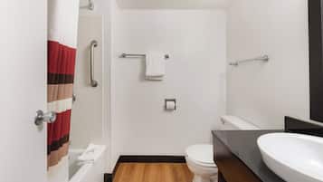 A bathroom with a shower, toilet, and sink.