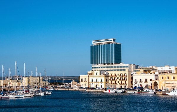 A marina with boats docked, a modern building, and traditional architecture. - Bellavista Club - Caroli Hotels (Gallipoli)