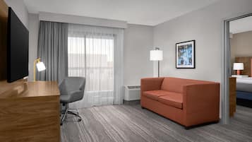 Suite, 1 King Bed, Non Smoking, Balcony | Living area | 55-inch flat-screen TV with cable channels, TV