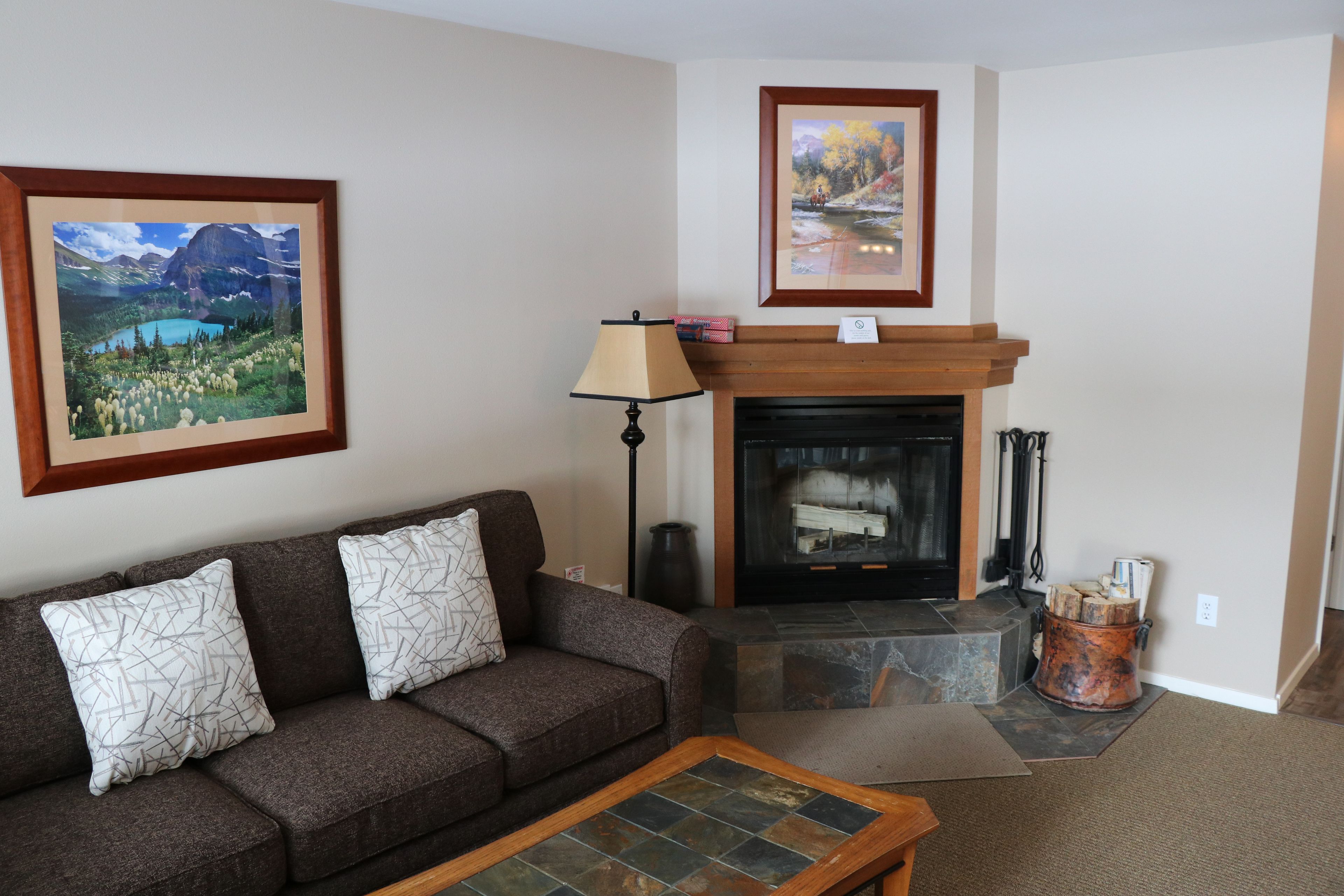 A living room with a fireplace, a sofa, and a coffee table.