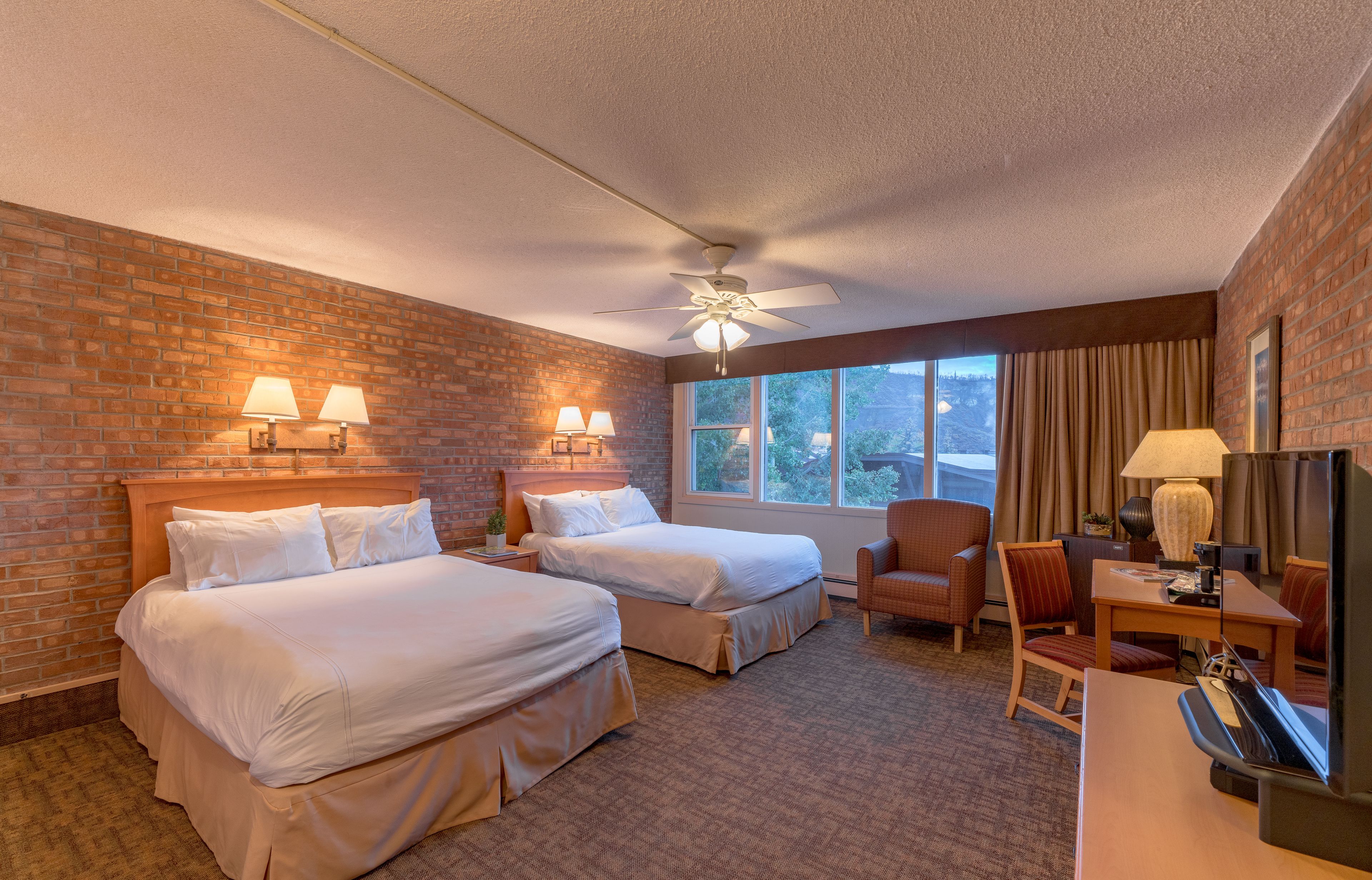 deluxe room, 2 queen beds | in-room safe, desk, iron/ironing board, free cots/infant beds