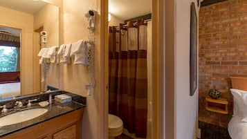 A bathroom with a sink, toilet, and shower curtain.