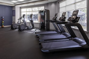 A gym with treadmills, stationary bikes, and a weight machine. - Hampton Inn & Suites Arlington Crystal City DCA (Arlington)