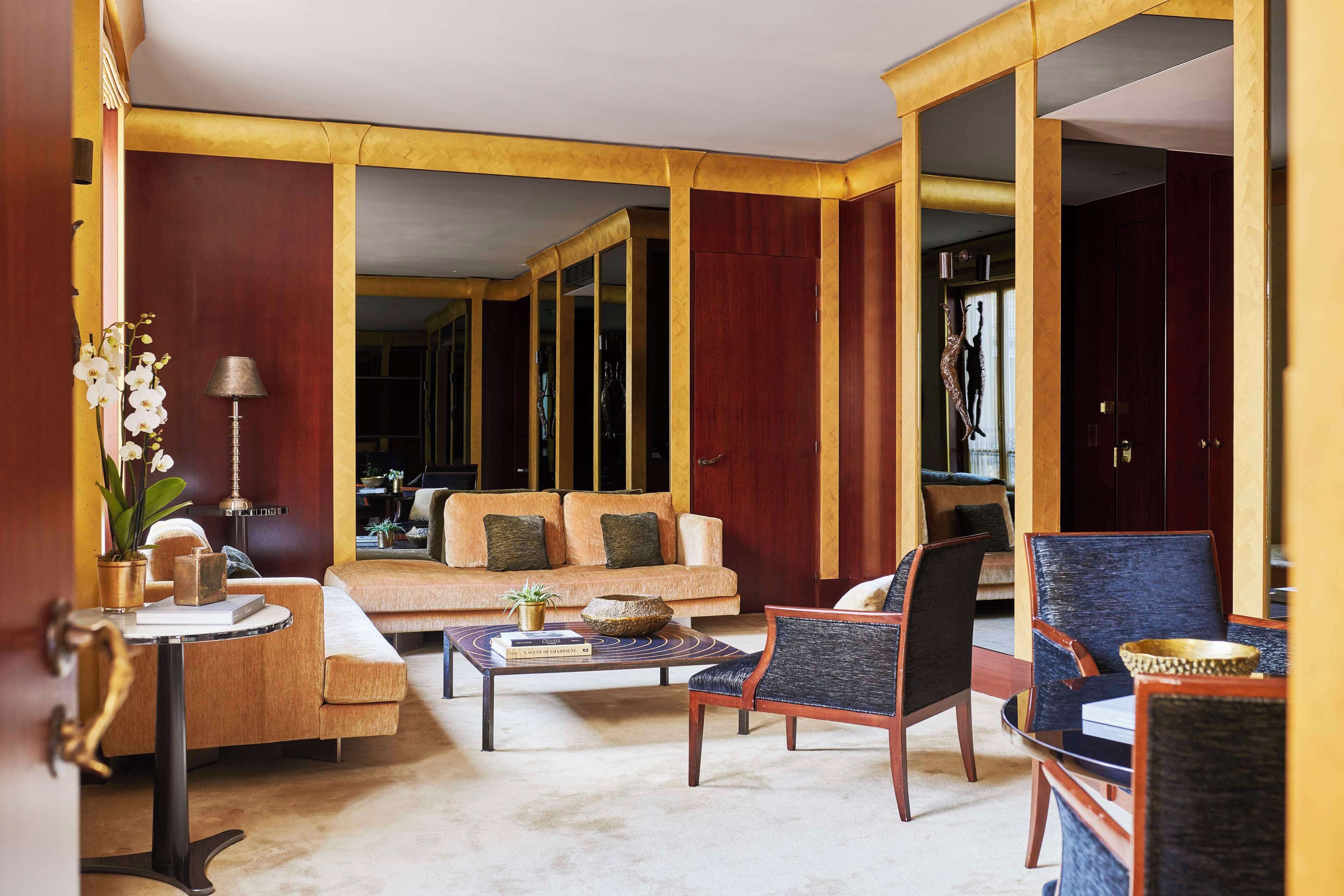 A spacious living room with a sofa, armchairs, and a coffee table.