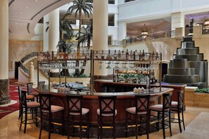 A bar area with a circular layout, multiple bar stools, and a central bar counter.