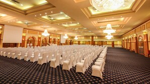 A large hall with rows of white chairs and a carpeted floor. - Steigenberger Nile Palace (Luxor)