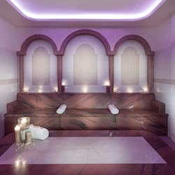 Experience serenity in this elegantly designed spa room featuring a marble bench, large table, and arched niches with frosted glass panels.