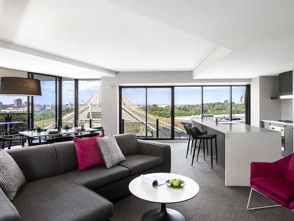Una sala moderna con un sofá, un comedor y una cocina.
