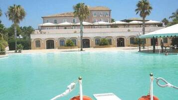 Relax by the pool surrounded by lush palm trees and enjoy a refreshing swim.