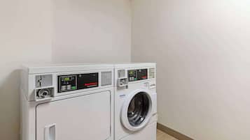 A front-loading washer and dryer unit with digital displays and control panels.