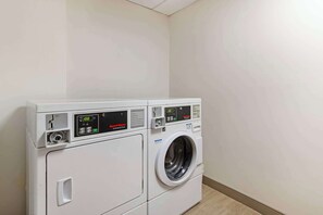 A front-loading washer and dryer unit with digital displays and control panels. - Comfort Suites Northside Hospital Gwinnett (Lawrenceville)