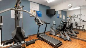 A gym with exercise equipment, a treadmill, and a mirror reflecting the space. - Comfort Suites Port Allen - Baton Rouge (Port Allen)