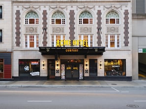 A building with a marquee reading 'ACME HOTEL COMPANY' and a sign stating 'ACME HOTEL NOT VACANCY'. - ACME Hotel Chicago, Outset Collection by Hilton (Chicago)