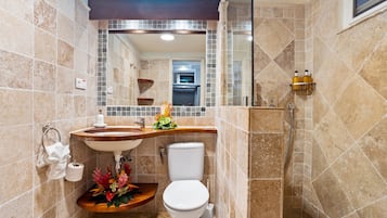 A bathroom with a sink, toilet, and shower.