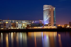 A modern hotel with a tall, cylindrical tower and a shorter building with multiple windows. - Clayton Hotel Limerick (Limerick)