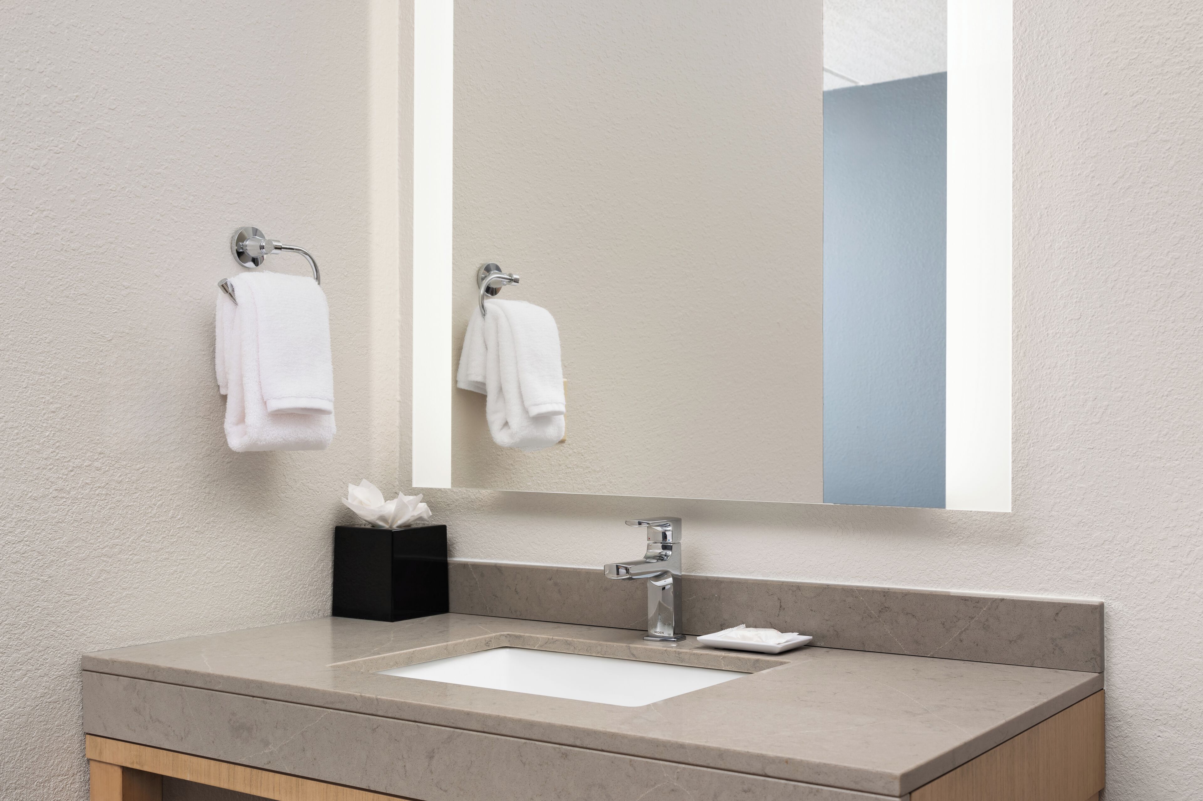 designer toiletries, hair dryer, towels