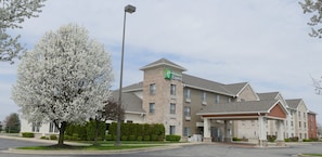 A Holiday Inn Express building with a brick facade, a covered entrance, and a parking lot. - Holiday Inn Express Greensburg by IHG (Greensburg)