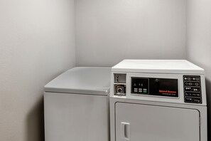 A commercial dryer with a control panel, a door, and a handle. - Super 8 by Wyndham Cloverdale IN (Cloverdale)